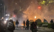 Riots brake out outside of the university, while the crowds throws a petrol bomb towards t...