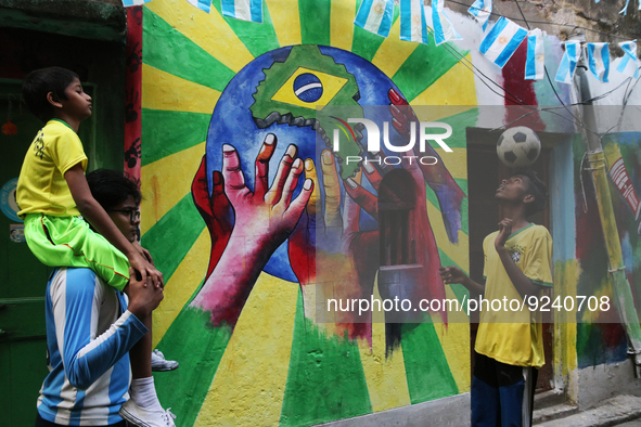 Brazil and Argentina supporters wearing favorite team  jersey playing football in front of an wall graffiti  to celebrate the Qatar 2022 FIF... by Debajyoti Chakraborty/NurPhoto