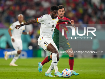 (10) BERNARDO SILVA of Portugal team battel for possession on ball with (5) PARTEY Thomas of Ghana team during FIFA World Cup Qatar 2022  Gr...