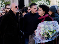 The parents of Valeria Solesin, Alberto (L) and Luciana (R) , her brother Dario (C) stand in front of the coffin of their daughter on Venice...