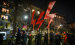 Activists carry three red lightning bolts, the main symbol of the pro-choice movement, whe...
