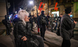 A young woman observes activists passing by during the 'Our Struggle Still Continues' prot...