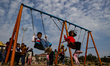 Kids swinging in a park in Jammu City, Jammu and Kashmir India on 09 December 2022 