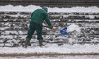 A man is removing snow during snowfall in the city as Arctic blast heads for Europe. Krako...