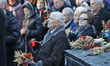 Ukrainians attend a memorial  ceremony near a monument to the victims of the Great Famine...