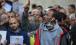 Demonstrators carry a portrait of Palestinian prisoner Nasser Abu Hamid, a cancer patient...