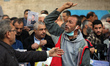 Demonstrators carry a portrait of Palestinian prisoner Nasser Abu Hamid, a cancer patient...