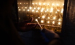 Ultra-Orthodox Jewish men light candles on the seventh night of Hanukkah in the Jewish Qua...