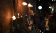 Ultra-Orthodox Jewish men light candles on the seventh night of Hanukkah in the Jewish Qua...