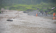 A tourist jeep is seen being swept away by the currents of the Yellow River in Yogyakarta,...