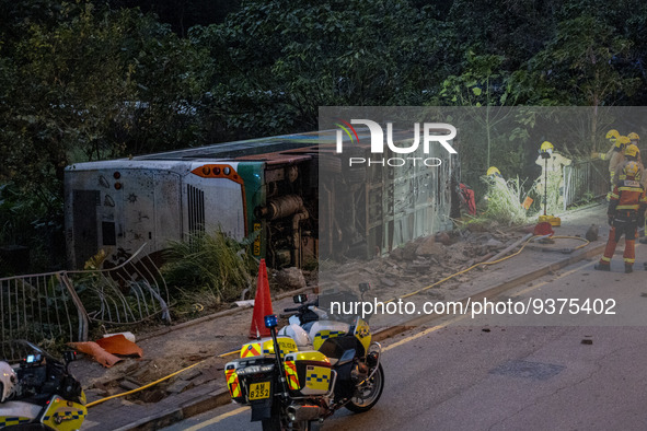A General view showing the rolled over double decker bus on January 1, 2023 in Hong Kong, China. Police say 13 passengers were injured in th...