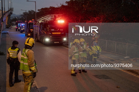 Firefighters and fire trucks near the site of a rolled over double decker bus on January 1, 2023 in Hong Kong, China. Police say 13 passenge...