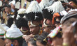 A Naga tribesman looks on as others performs on the third day of the state annual Hornbill...
