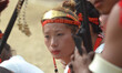A Naga tribesman looks on as others performs on the third day of the state annual Hornbill...