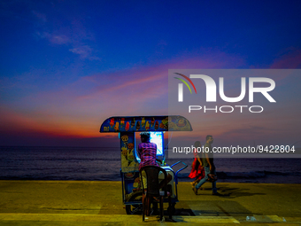 A vendor sells ice cream from his cart on the Galle Face promenade in Colombo, Sri Lanka, on January 11, 2023. (
