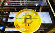 Bitcoin symbol is displayed in a window of a money exchange office in a shopping center in...