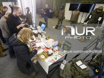 Journalists look at combat equipments of Russian soldiers during a media briefing of the Security and Defense Forces of Ukraine in Kyiv, Ukr...