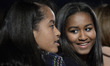 First daughters Malia Obama, left, and Sasha Obama, right, smile during the National Chris...