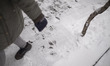 A young Iranian woman walks along a street-side in downtown Tehran during snowfall, Januar...