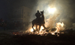 A horseman rides through a bonfire during the traditional festival of ''Las Luminarias'' i...