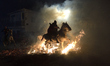 A horseman rides through a bonfire during the traditional festival of ''Las Luminarias'' i...