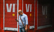 A man is seen using mobile phone in front of a closed Vodafone store in Kolkata , India ,...