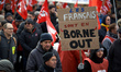A woman holds a placard reading 'Frecnh people are in borne out'. Borne is the name of the...