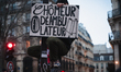 A demonstrator holds a sign with the slogan 'Chomeur en deambulateur' during the demonstra...