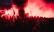 A compact crowd walks amid union balloons and red smoke flares during the demonstration wh...