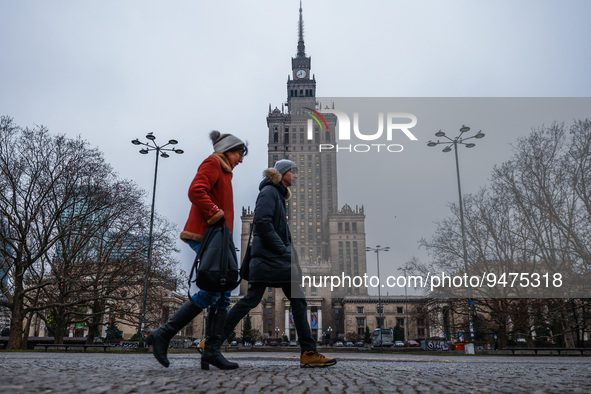 People walk near the Palace of Culture and Science in Warsaw, Poland on January 19, 2023. Seagulls flying near the Palace of Culture and Sci...