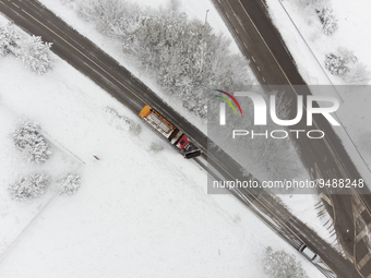 A snowplot at work is seen in an aerial drone view after a snowfall in L'Aquila, Italy, on January 23, 2023. Central Italy is involved in a...
