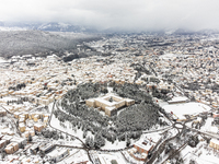 Forte Spagnolo castle and a cityscape in an aerial drone view are seen after a snowfall in L'Aquila, Italy, on January 23, 2023. Central Ita...
