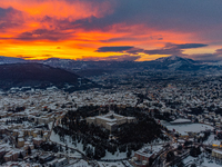Forte Spagnolo castle is seen in a sunset aerial drone view after a snowfall in L'Aquila, Italy, on January 23, 2023. Central Italy is invol...