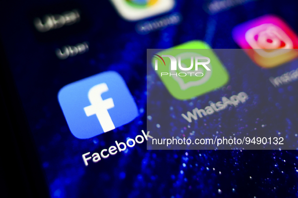 Facebook and WhatsApp logos are displayed on a mobile phone screen for illustration photo. Krakow, Poland on January 23, 2023. 