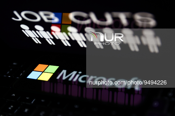 'Job cuts' sign and stick figures image displayed on a laptop screen and Microsoft logo displayed on a phone screen are seen in this illustr...