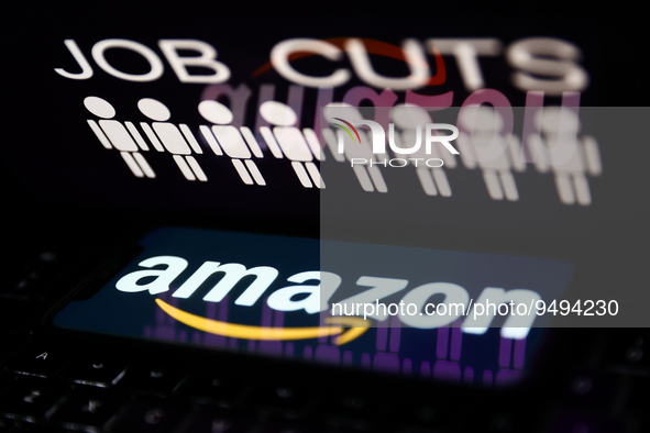 'Job cuts' sign and stick figures image displayed on a laptop screen and Amazon logo displayed on a phone screen are seen in this illustrati...