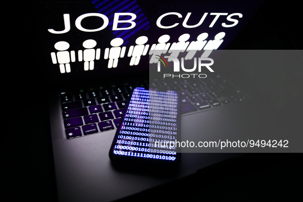 'Job cuts' sign and stick figures image displayed on a laptop screen and a binary code displayed on a phone screen are seen in this illustra...