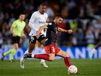 Vivian (R) Athletic Club competes for the ball with Samuel Lino of Valencia CF during the Copa del Rey Quarter Final match between Valencia...