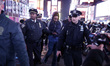 A man is detained after his arrest for vandalizing a NYPD car  in Times Square as the beat...