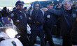 A man is detained after his arrest for vandalizing a NYPD car  in Times Square as the beat...