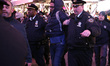 A man is detained after his arrest for vandalizing a NYPD car  in Times Square as the beat...