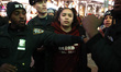 A woamn is arrested as people demonstrate in Times Square as the beating video of Tyre Nic...