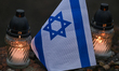 Israeli flags and candles left at  at the ruins of the gas chamber and crematorium IV of t...