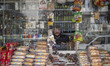 An Iranian salesman poses for a photograph while sitting at a stall in downtown Tehran, Ja...