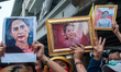 

Protesters are shouting slogans while holding pro-democracy signs and pictures of depose...