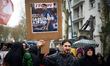 A protester holds a frontpage of the 'L'Equipe' newspaper reading 'Raphael Varane: retirem...