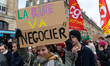 A young protestor holds a placard reading '' the street will negotiate '' during a demonst...