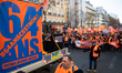 Demonstrators from the CFDT (French Democratic Confederation of Labor) union walk behind a...