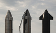 A SpaceX worker makes final adjustments to Starship 24's TPS tiles ahead of its orbital la...