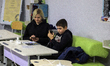ODESA, UKRAINE - FEBRUARY 8, 2023 - A woman and a boy charge their phones and access the I...